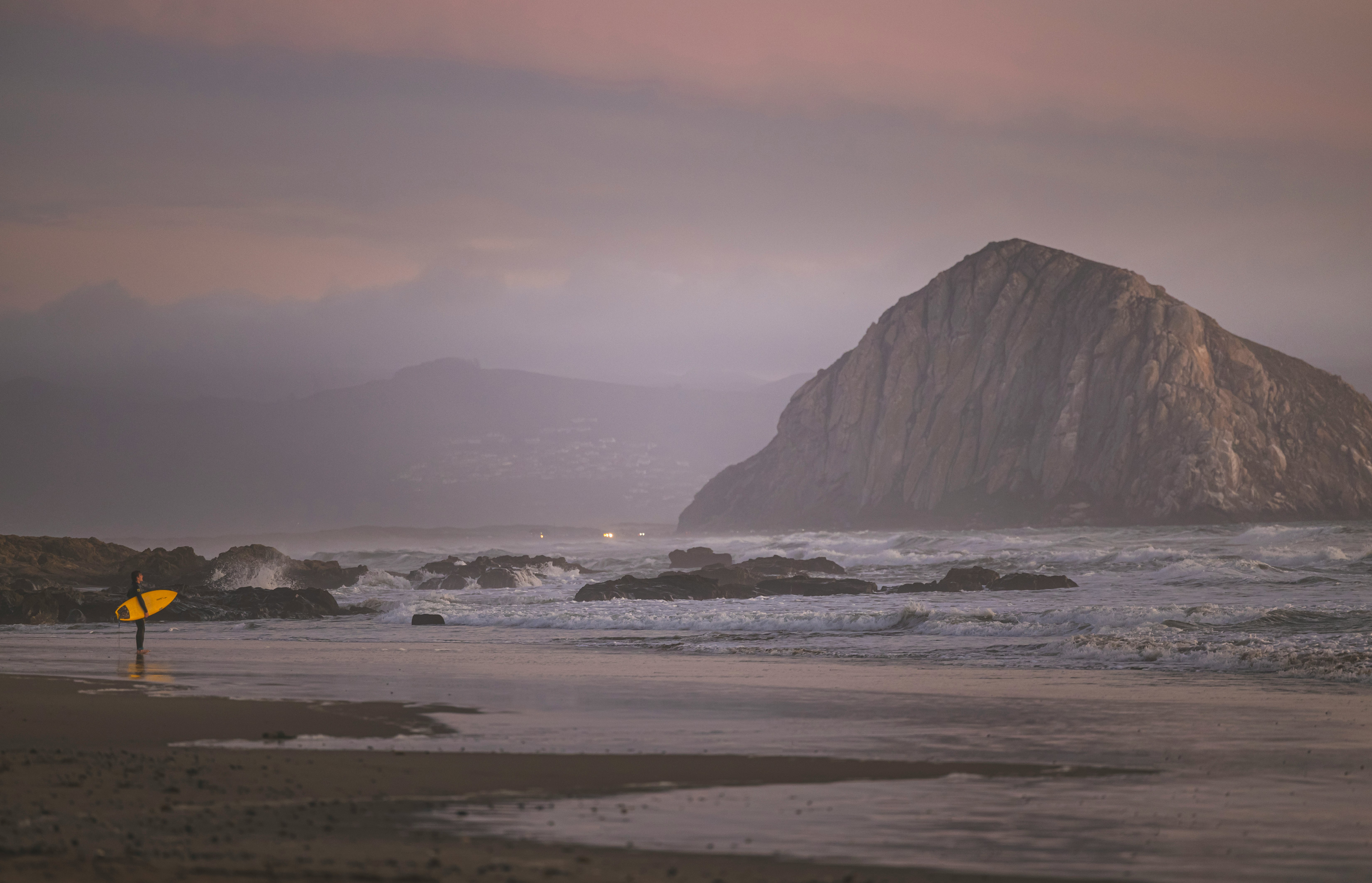 brown rock formation on sea water during daytime